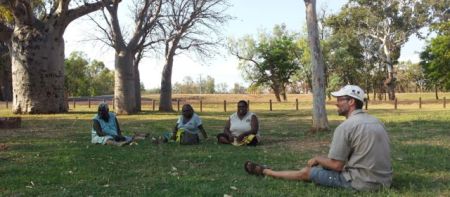 Joking under the boabs towards the end of a hot day visiting potential field site